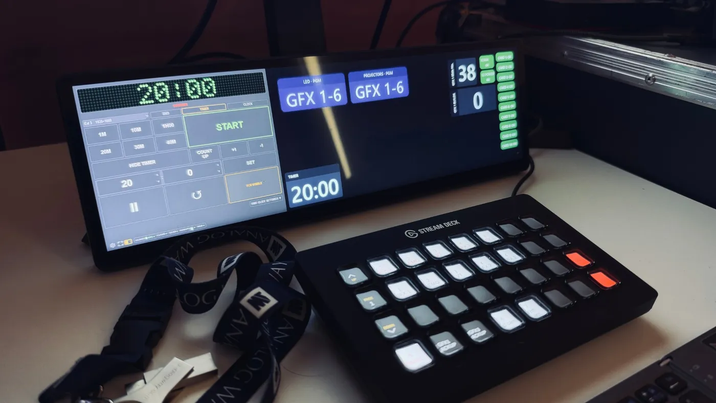 A Corsair Xeneon Edge bar screen with KUMA Timer in a strip on the left and a dashboard of output buttons on the right, with a Stream Deck below